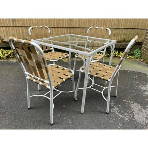 A vintage set of indoor or outdoor aluminum table and chairs. The square table measures 32" x 32" x 29.5"H and features a...