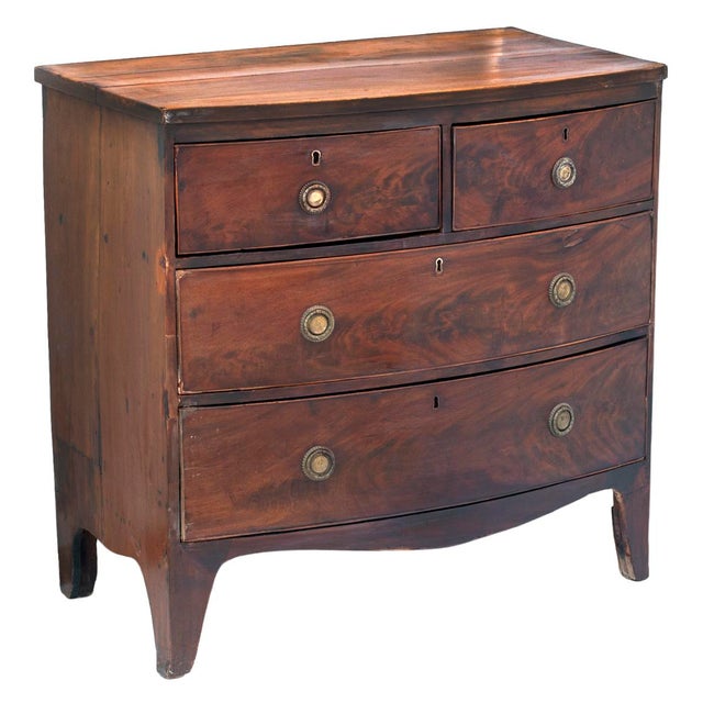 Early 19th-century George III period walnut bow-front chest of drawers. Handcrafted from beautifully figured wood. The...