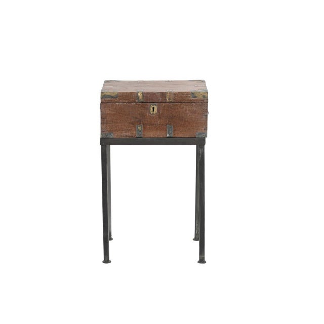 This Vintage Anglo-Indian Teak and Brass Small Chest on Iron Legs/Side Table is handcrafted from solid teakwood, enhanced...