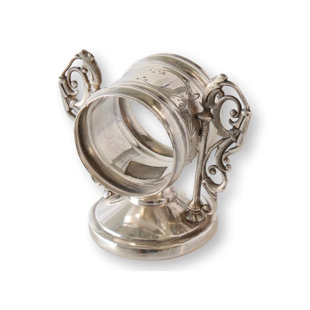 A beautifully detailed Victorian silver plate napkin ring by Hall, Miller & Co., featuring engraved banding and a pedestal...