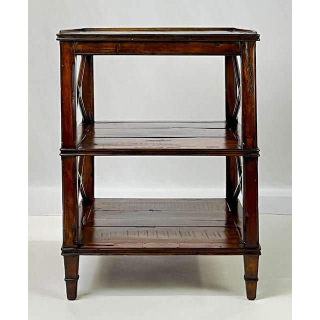 A sophisticated three-tier side table by Theodore Alexander, part of the acclaimed Castle Bromwich Collection. This piece...