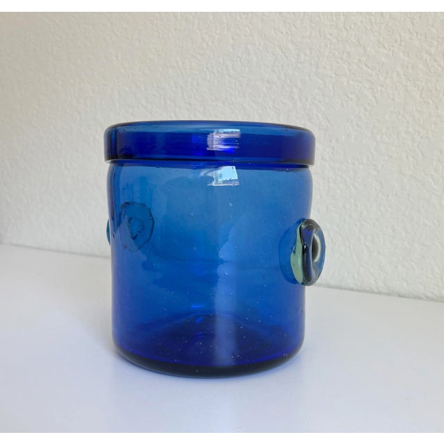 Stunning mid-century modern ice bucket or wine bottle chiller. It features a vibrant cobalt blue body with clear glass...
