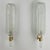 Pair of wall lights in thick, transparent glass in the shape of palm fronds mounted on brass supports. The design of these...