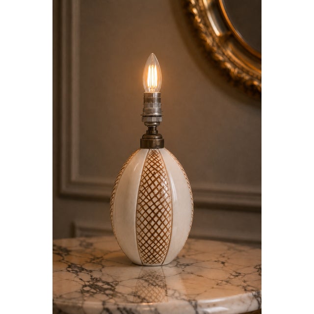 An exceptional and highly collectible art deco ceramic table lamp by the prestigious maker nildes. Characterized by a...