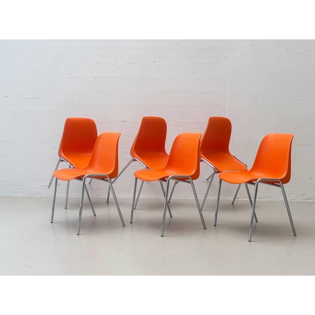 This stacking chair by helmut starke, with its vibrant orange seat shell, brings the characteristic charm of the 1970s to...