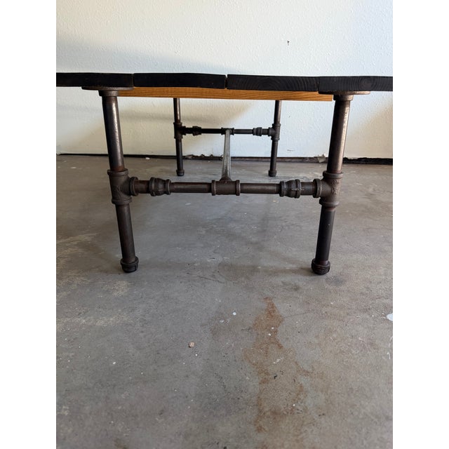 This custom-crafted coffee table perfectly captures the rugged elegance of modern industrial design. It features a heavy,...