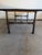 This custom-crafted coffee table perfectly captures the rugged elegance of modern industrial design. It features a heavy,...