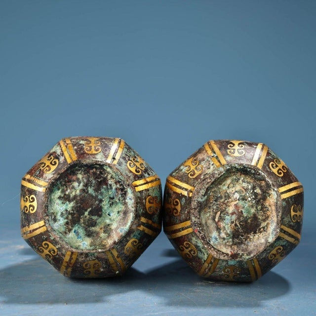 This matching pair is masterfully crafted from solid bronze with a rich, mottled green and brown patina. They feature...