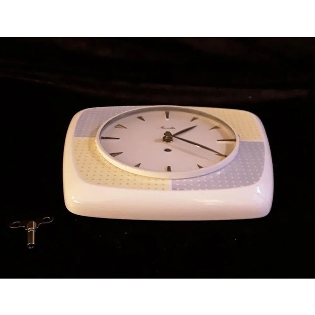 Mid-Century Modern Mid-Century German Machanical Wall Club Clock in Cream-Colored Ceramic with Yellow-Blue Decor from Mauthe, 1950s For Sale - Image 3 of 5