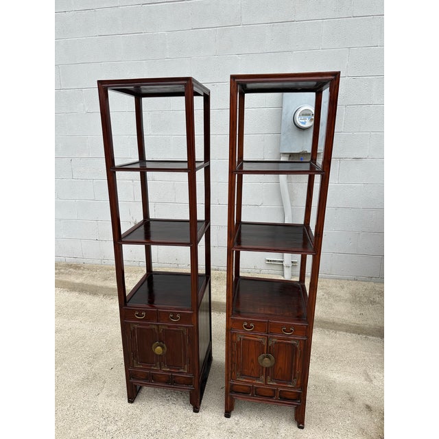 Pair of vintage Korean elmwood 3 tier etagere/ curio cabinets. 2 open shelves over 2 drawers with brass hardware above two...