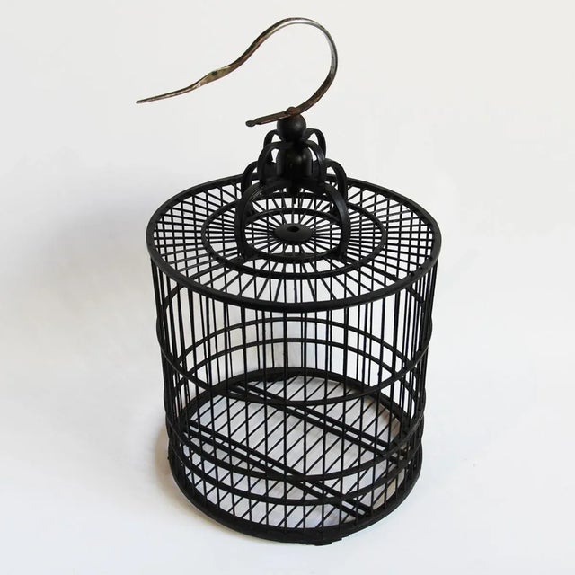 Offered is a black stained bamboo bird cage with a metal hanging hook. This is a great styling piece for your glam boho...