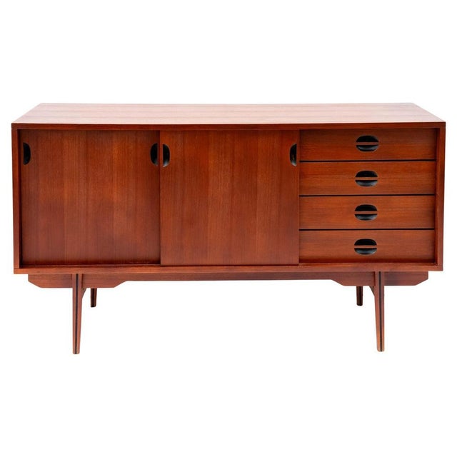 Scandinavian sideboard, 1960s. Sideboard made of patinated teak veneer wood, with essential line and right proportions. It...