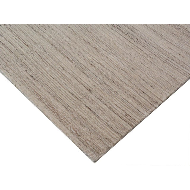 Bring a sense of harmony and balance to any setting with the Banburr Rug. The soft textured pile and beautiful linear,...