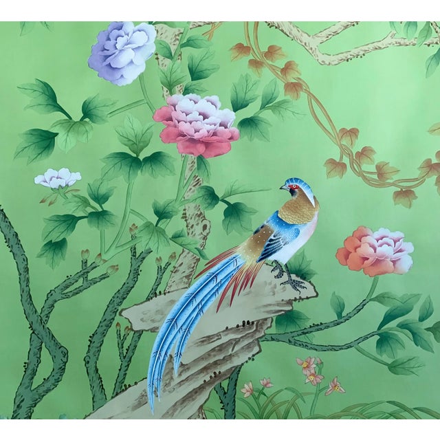 Exquisite hand-painted chinoiserie mural set with soft sage green backdrop, showcasing blooming peonies, lotus, varied...