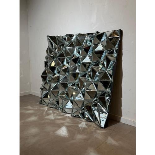 Spectacular large sculptural mirror composed of dozens of faceted mirrored panels arranged in a dynamic geometric...