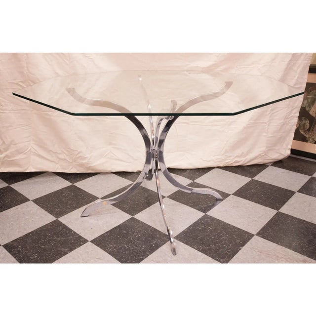 This is an authentic 1970’s French chrome and glass table. The glass top features a hexagon shape, while the base is...