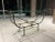 Homage to Giacometti Etruscan console sofa table in bronze finish with heavy 3/4” thick water rounded edge glass top,...