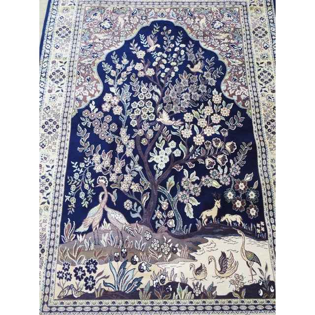 Soft shades of navy blue, lavender and cream make this rug a beautiful melody of silk. Flowers, trees and a variety of...