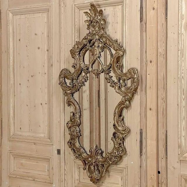 Antique Italian Baroque Giltwood Wall Mirror represents the essence of the style born of the creative minds of Italian...