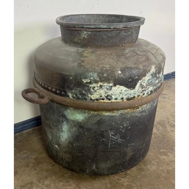 A striking antique copper storage vessel, hand-forged with a beautifully timeworn surface and rich verdigris patina. This...