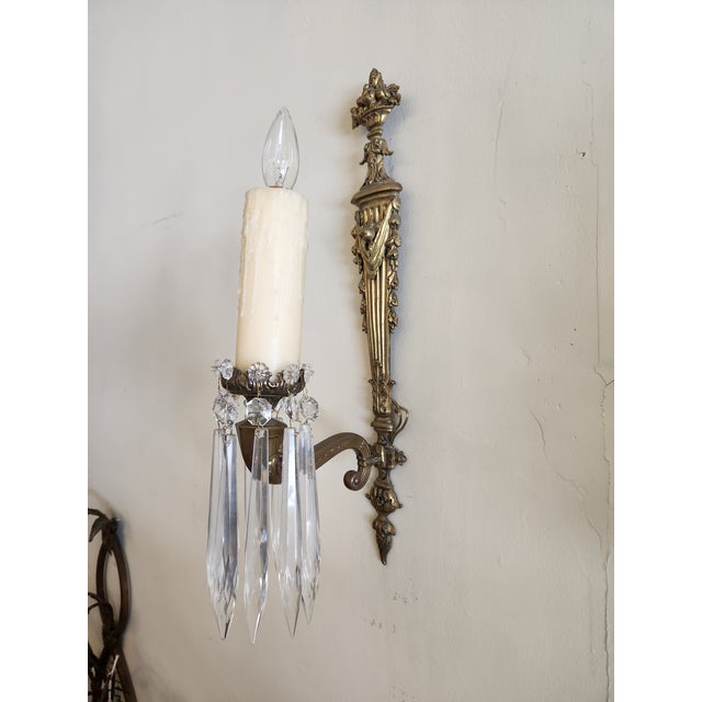 Pair solid brass, beeswax candle sleeve, single candelabra bulb. Artist or maker is unknown.