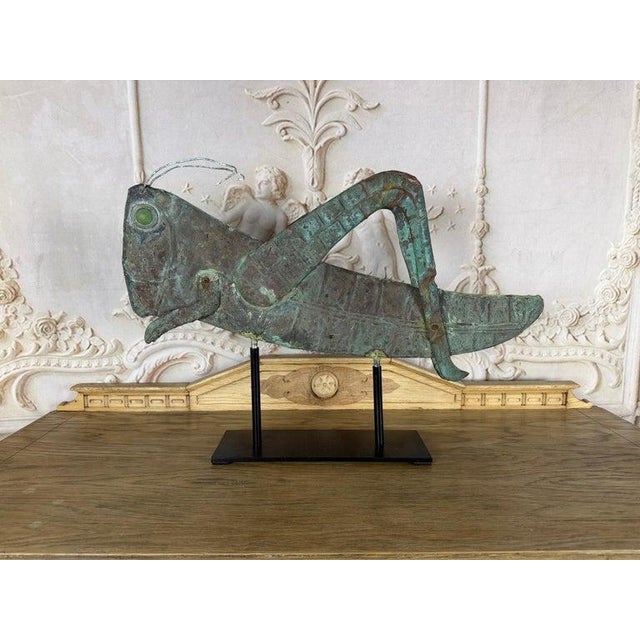An exceptional vintage copper grasshopper weathervane sculpture with a richly aged verdigris patina and striking...