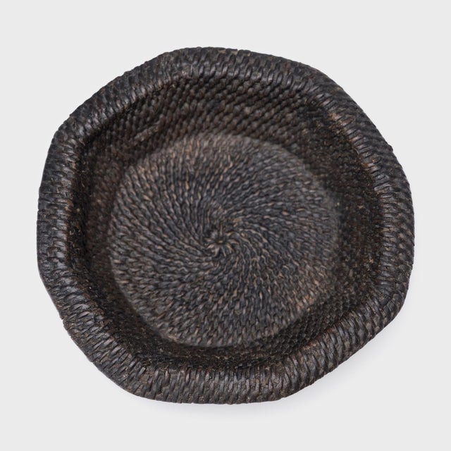 This small woven tray from the early 20th century celebrates the beautiful simplicity of a hand-woven object. The plate is...