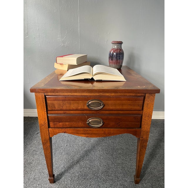 A refined Federal Style mahogany side table by Lane, distinguished by its beautifully executed marquetry top. The...