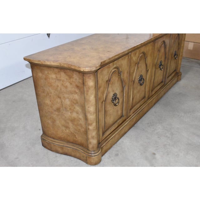 Gorgeous Hollywood Regency burl wood credenza designed by William Doezema for Mastercraft. Features 4 doors that open and...