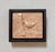 This artwork features a meticulously carved depiction of a nuthatch perched on a textured branch, showcasing the artist's...
