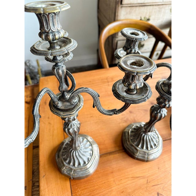 Elegant and sculptural, this pair of antique-style silver gilt candelabras makes a dramatic statement on any dining table,...