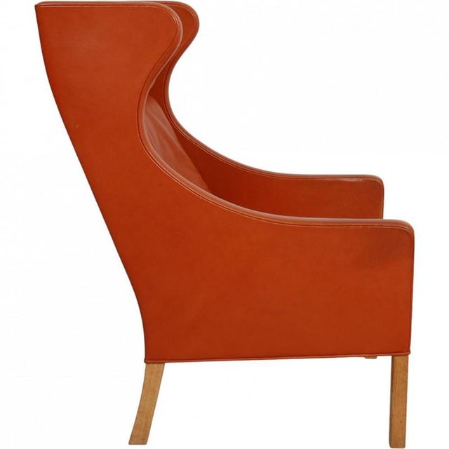Børge Mogensen wingchair, model 2204, upholstered in original cognac leather and with legs of oak. The chair is from the...