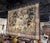 This antique French Aubusson verdure tapestry was handwoven circa 1870 and depicts a lush wooded landscape animated by...