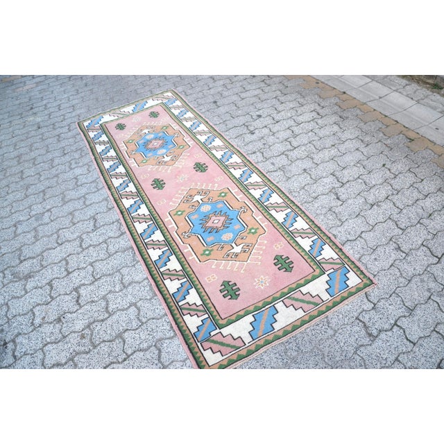 This is a vintage Turkish Oushak rug from the 1960s. The piece was hand-knotted.