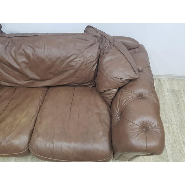 Elegant, original leather Chesterfield sofa. Covered with natural brown leather. A deeply quilted sofa will give the...