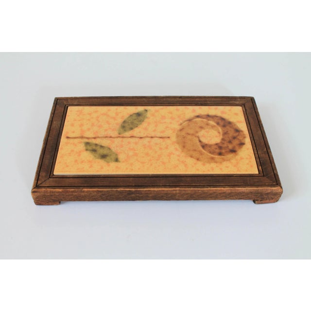 Vintage floral tile and wood trivet or wall hanging. Tile is marked "Made in Spain". Some age wear to wood.