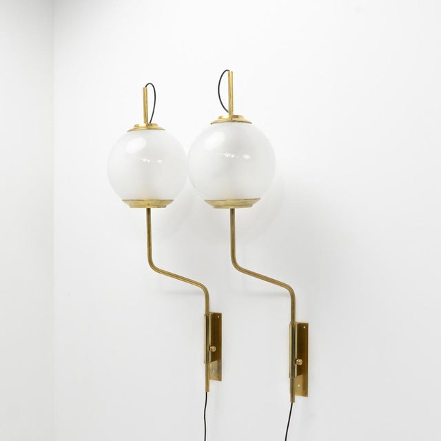The lamps rotate and are height adjustable. Brass and opaline glass. Wiring and sockets replaced, A very little chip on...