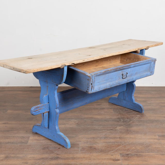 Early 19th-century rustic Swedish console table crafted in pine with a narrow profile and long drawer. The natural pine...