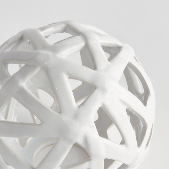 This contemporary little orb is made of thin ceramic strips giving it an open feel. It is perfect in a wide open bowl or...