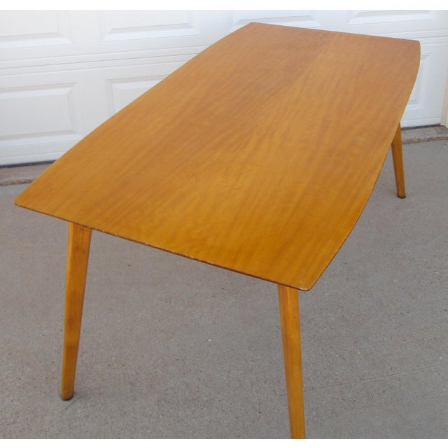 Vintage mid century modern wooden dining table made by Henry Roberts Furniture of Brisbane, Australia. The table top is...