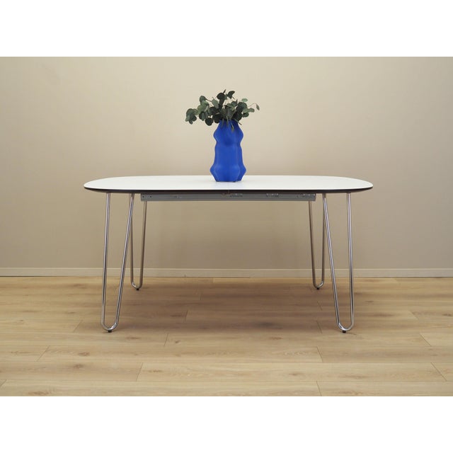 The table was made in the 1990s, Italian production. The table top is made of furniture board covered with laminate in...