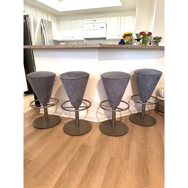 Four very unique Mid Century Modern Gray Blue Slate Suede Bar Stools with chrome footrests and heavy metal bases. The...