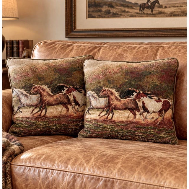 Vintage pair of Chris Cummings equestrian art tapestry pillows featuring a richly colored scene of running horses in warm,...