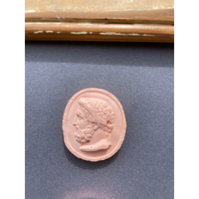 Immerse yourself in the enduring allure of classical antiquity with this truly unique collection of framed intaglios....