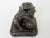 A superb bronze Japanese Buddhist lion, shishi, with one paw on a pierced ball. Artist signed on bottom of statue....