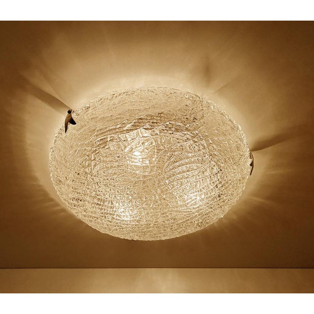 Large vintage Murano glass flush mount light with a structured glass mounted on a silver enameled base and chromed claws....