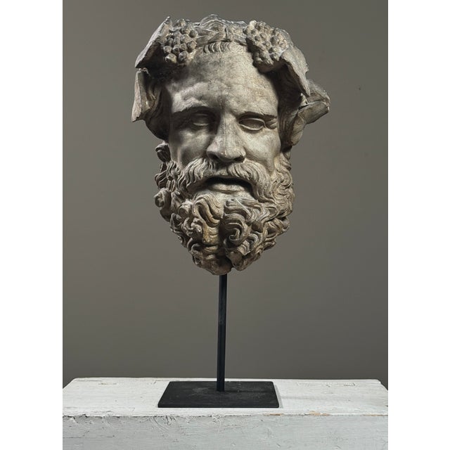 Antique Neoclassical Portrait Mask of Silenus Dimensions: 12.5” H x 9.5” W x 5” D Medium: Cast Plaster with Grey Patina...