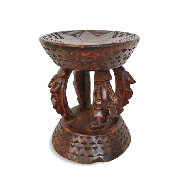 Vintage carved wood round stool from Mali. Beautiful aged chestnut finish. Carved star on top and triangular design...