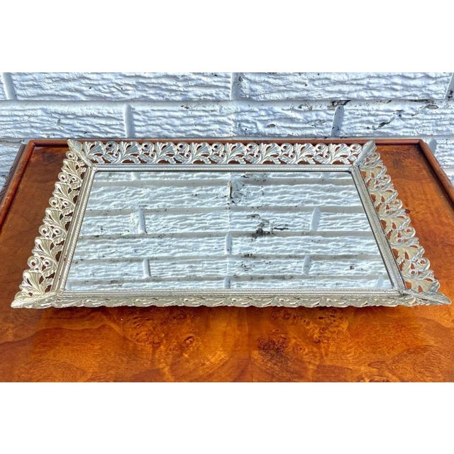 This is an absolutely gorgeous vintage gold filigree vanity tray with mirror. Back is felt covered and can be propped up....