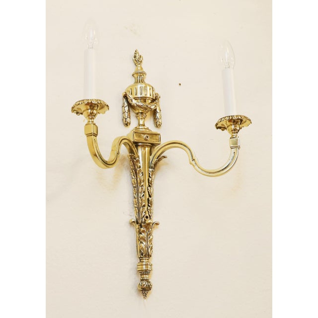 Applike Wall lamp, circa 1900. Solid cast brass in the Louis XVI style. Two curved arms with sockets. The lamp has been...